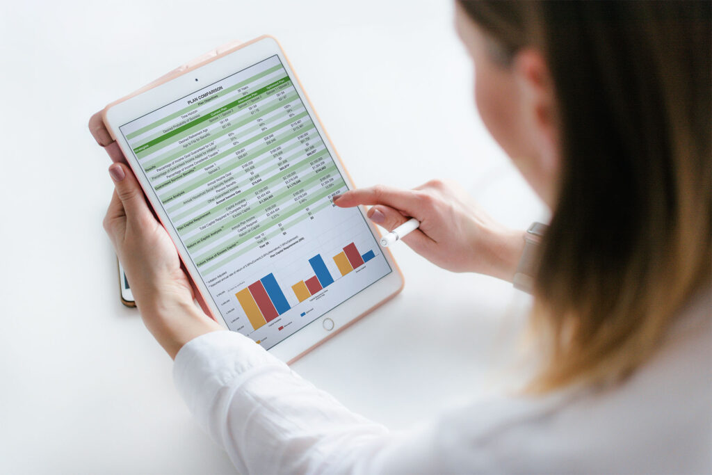 Shot from the back of a woman looking at her Free Income Stress Test results on an iPad